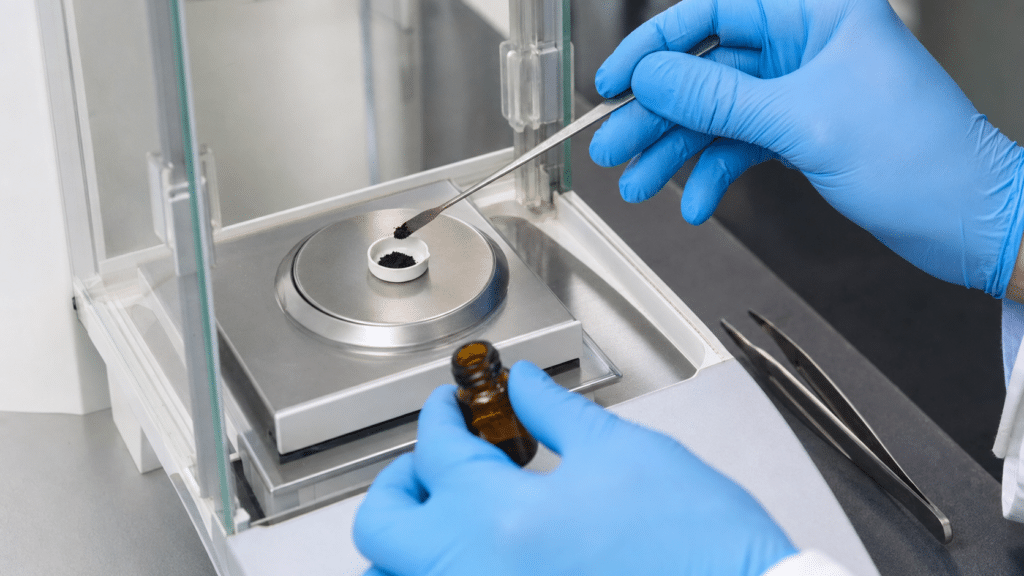 C60 TGA and DSC: How to Interpret Fullerene Thermal Analysis 12 Scientist weighing a small C60 powder sample into a TGA pan