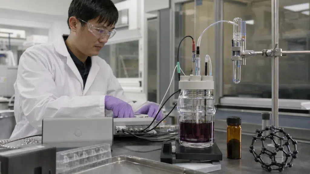 Electrochemist operating a three-electrode cell for C60 cyclic voltammetry